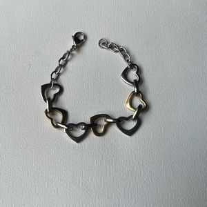 Silver tone and gold tone heart charm bracelet